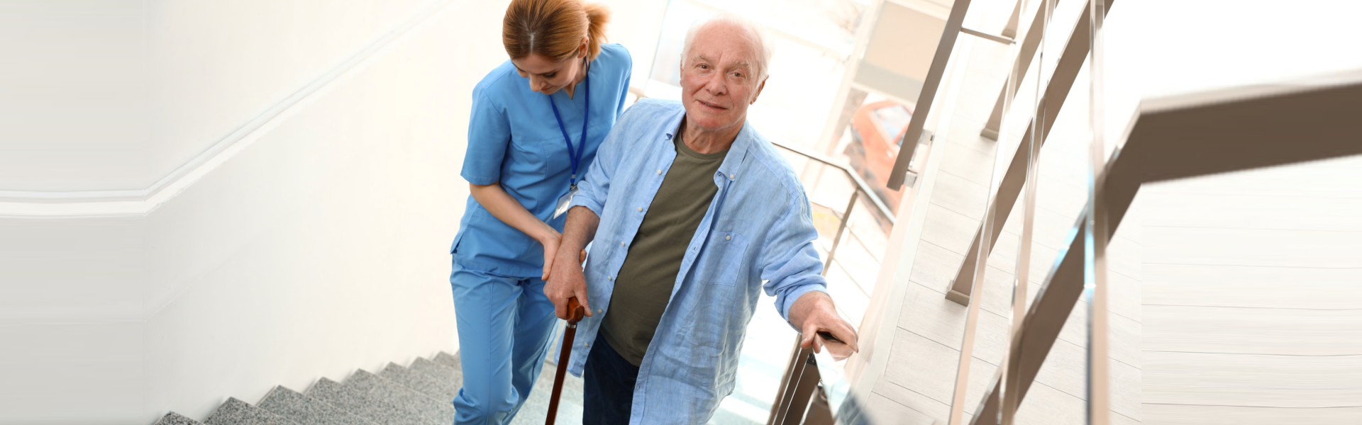 caregiver and elderly going upstairs