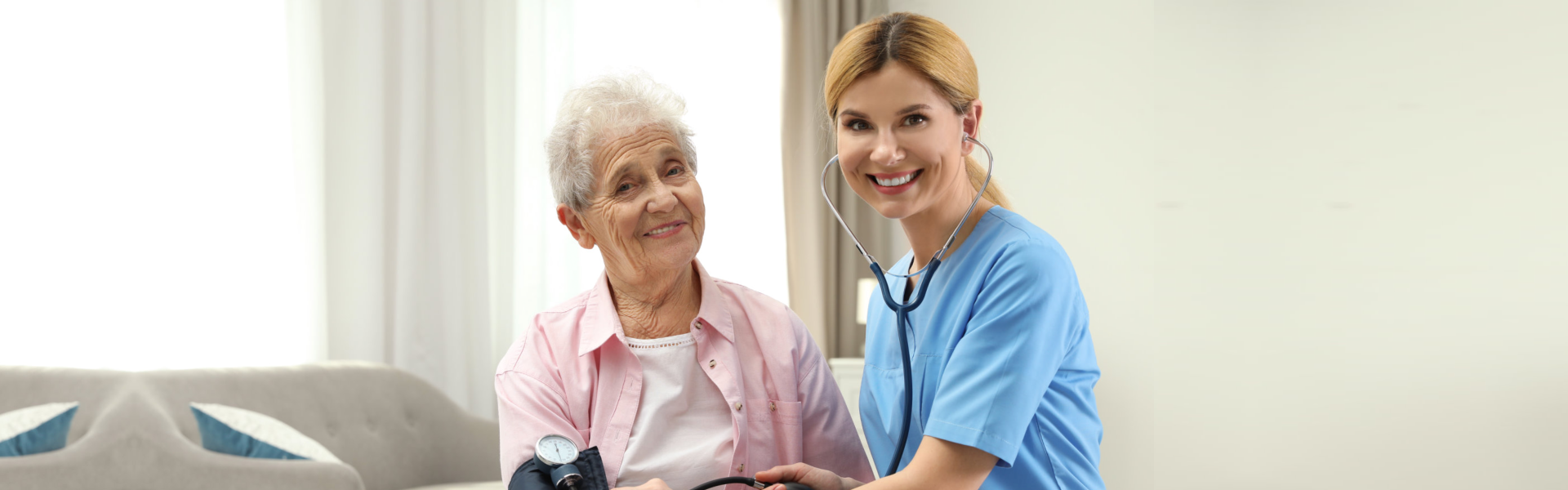 caretaker checking the blood pressure of the elderly