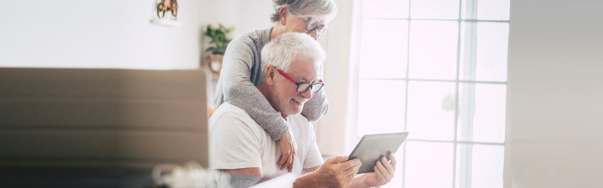 elderly couple reading a news in their tablet