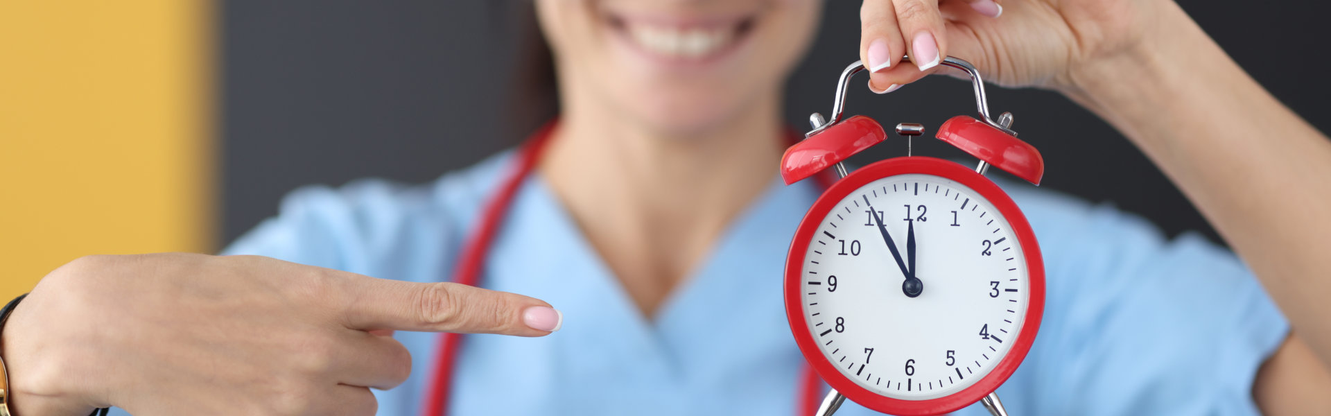 caregiver holding a red clock