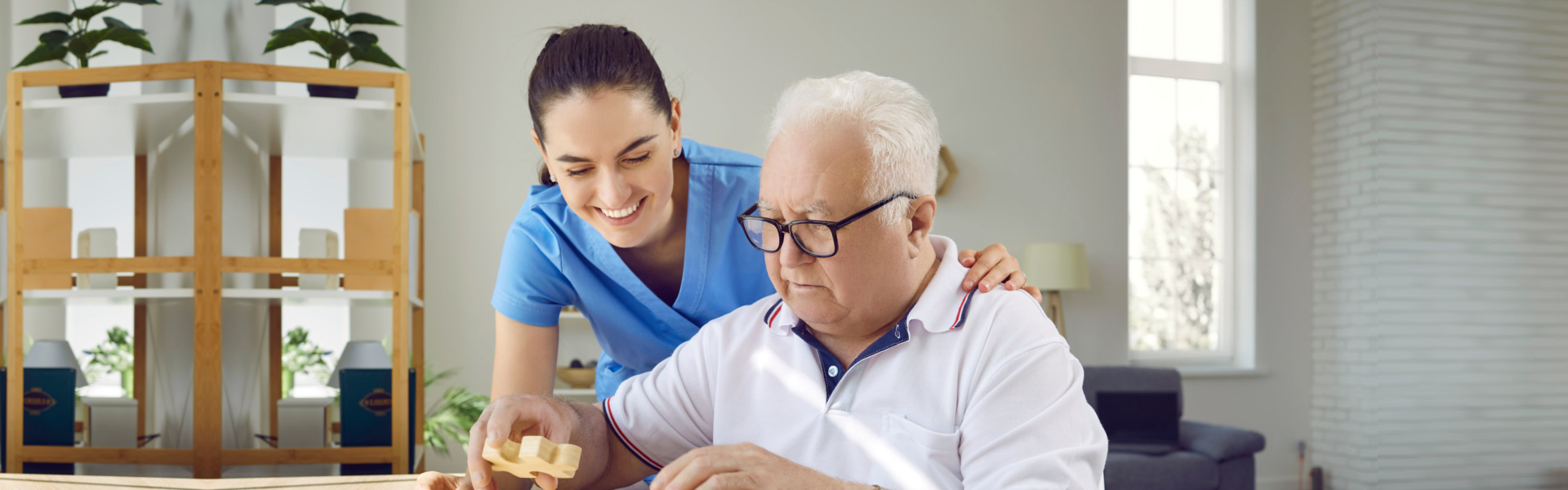 elderly man and caregiver playing a puzzle